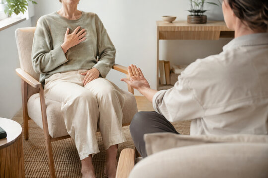 1 on 1 breathwork session with facilitator helps woman relax deeply and connect with her inner calm in cozy living room setting