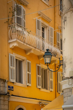 Yellow building facade with shutters and balcony, Corfu Town, Corfu, Greece