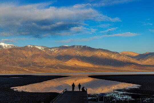 Photographers take in rare reflection at Badwater Basin on Lake Manly in Death Valley National Park, California, USA.