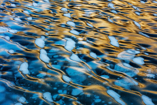 Ice ripples and methane ice bubbles under clear ice on Abraham Lake near Nordegg, Alberta, Canada.