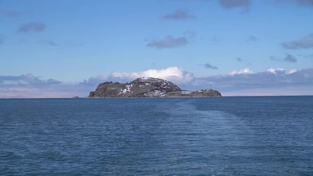 Akdamar Island on Lake Van, Turkey, seen from a departing boat with its wake, home of the Armenian Church of the Holy Cross, in winter