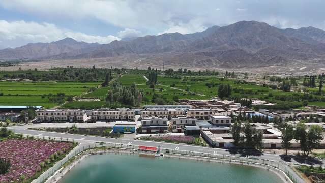 Highland village landscape with terraced fields and distant mountains