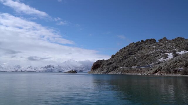 Lake Van, Turkey, near Akdamar Island in winter, calm water along a rocky shore with snowcapped mountains, the largest lake in Turkey