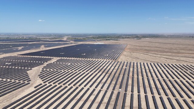 rows of solar panels in vast desert landscape