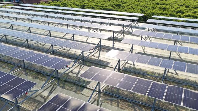 Aerial view of rows of solar panels installed in a field in Faenza, Emilia-Romagna, Italy.