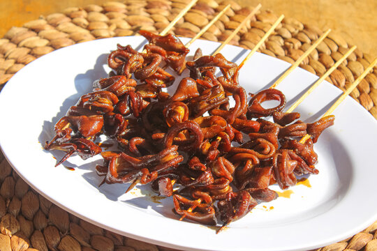 Close Up View Of Grilled Chicken Intestine Satay On White Plate