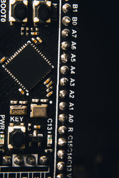 A close-up of a microcontroller; a series of photos on the topic of hardware and embedded systems.