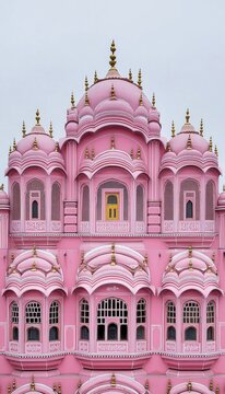 Stunning faade of Hawa Mahal in Jaipur, India, showcasing intricate pink architecture and design.
