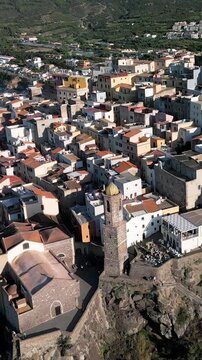 Panoramic aerial view of the Castelsardo, a medieval town in northern Sardinia (Sassari province) on the Gulf of Asinara. It features cascading, colorful houses and a historic fortress.