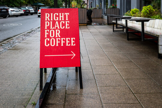 RIGHT PLACE FOR COFFEE Sign Outside a Rainy Urban Cafe