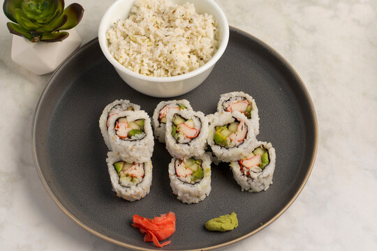  stacked california rolls served with a side pf rice