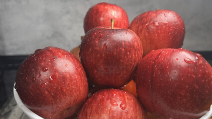 Fresh red apples with water drops on them piled in a bowl, healthy food and organic fruit concept    © mohammad