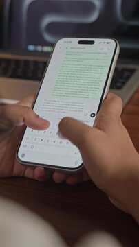 Woman's hand chatting and typing on a smartphone, macro closeup. Unrecognisable human typing a text message, tapping the touchscreen keyboard using the WhatsApp application, a social media.