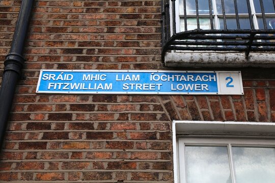 Fitzwilliam Street Lower sign in Dublin city, Ireland. Street name in Irish and English language.