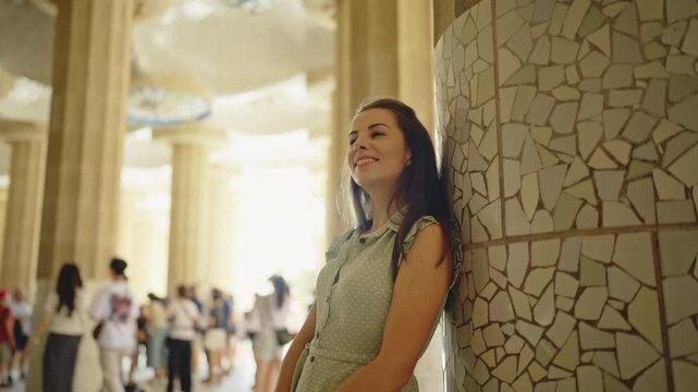 Woman Admiring Gaudi Mosaic Columns Inside Park Guell Barcelona