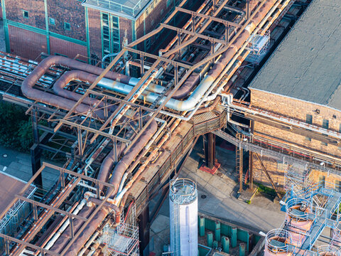 Aerial view of the Heizkraftwerk Klingenberg combined heat and power plant featuring complex industrial piping systems and brick architecture in Berlin, Berlin, Germany.