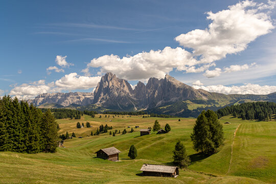 Seis, Italy - August 26, 2026: Cabins overlooking the Sassolungo massif