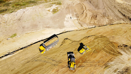 Aerial View of Dump Truck and Earthmoving Machinery at Construction Site © Andrey