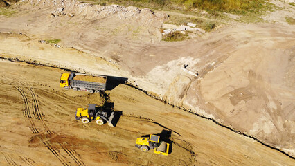 Aerial View of Dump Truck and Earthmoving Machinery at Construction Site © Andrey