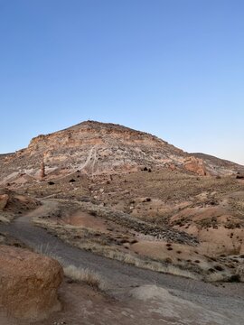 Aktepe hill and a dirt trail above Red Valley in warm light