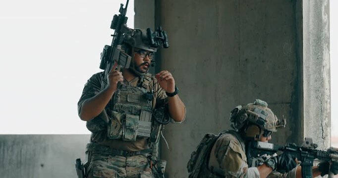 Military tactical operator moves between concrete pillars above city during urban operation