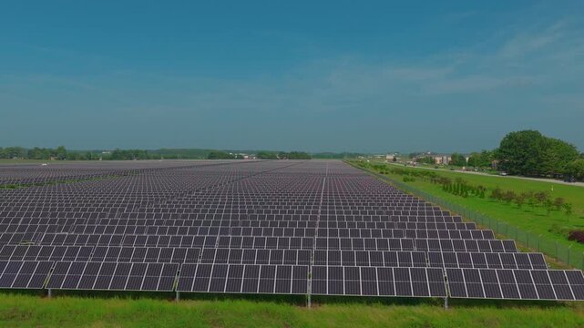Utility-scale solar rows feeding the grid &mdash; a timely visual for stories on AI and data center electricity demand, corporate clean-power buying and grid capacity.