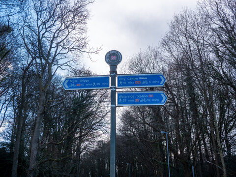 National Cycle Network Route 93 sign in Derry, Northern Ireland, directing cyclists and pedestrians towards Foyle Bridge, the city centre and Waterside railway station.
