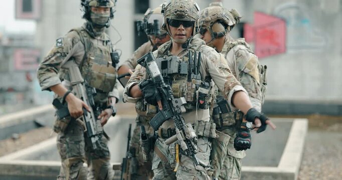 Military tactical team briefing with rugged laptop while leader points out the objective