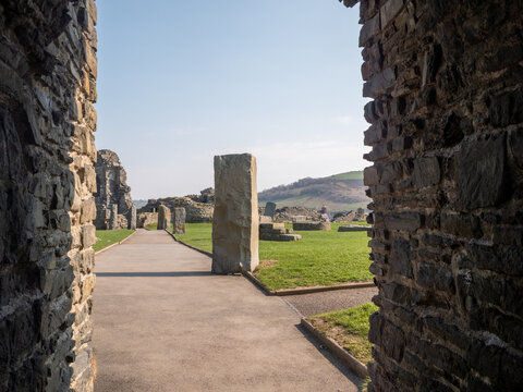 Aberystwyth Castle, closeup view of standing stone through castle gateway, set against a clear blue sky.