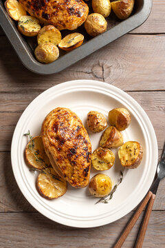 Oven roasted lemon garlic chicken and baby potatoes on plate