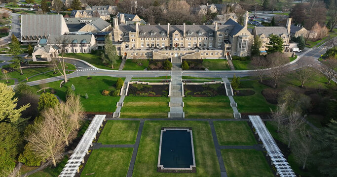 Aerial view of the historic Masonic Village featuring stone architecture, lawns, gardens, and a reflecting pool in West Donegal Township, Pennsylvania, United States.