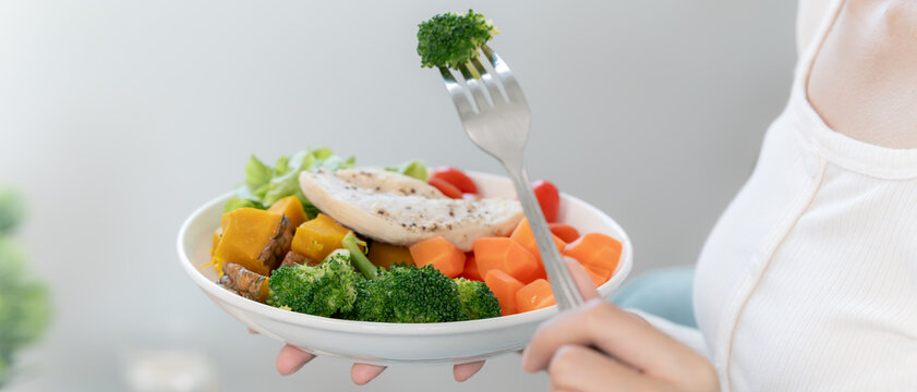  Diet and dieting, enjoy eat. Healthy Asian woman hold salad food and feeling happy. Beauty slim female body achieves weight loss goal for healthy life, crazy about thinness, thin waist, nutritionist.