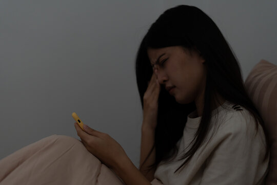 Eye problems, Asian women with tired and irritated eyes, eye rubbing, dry, eye pain after work, migraine, headache, blurred vision, photophobia, working in the dark, blue light from compute
