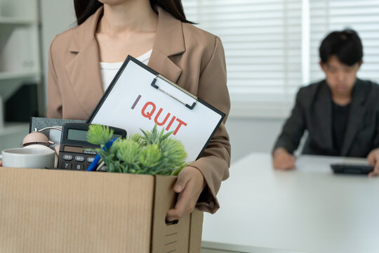 resignation, leave, quit, Stressful businesswomen will resign from the company. Female staff is lifting a brown paper box that holds personal items. , job placement and vacancies, resignation letter