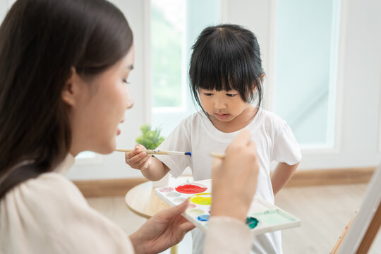 Mother day, Happy Asia mother play and learn drawing for little girl. Funny family is happy and excited in the house. Mother and daughter  having fun spending time together. Holiday, Activity
