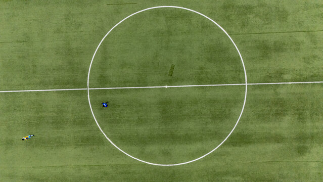 Aerial view of Lagos Island soccer field with two players on the green turf in Lagos, Lagos, Nigeria.
