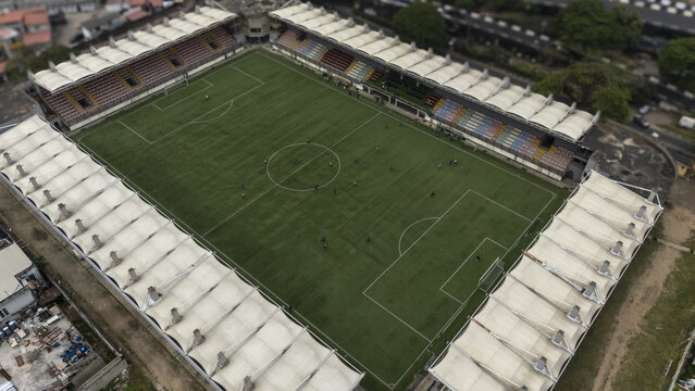 Aerial view of the Mobolaji Johnson Arena on Lagos Island with its distinctive white canopy roof and green pitch surrounded by urban infrastructure in Lagos, Lagos, Nigeria.