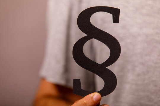 The iconic paragraph mark signifies legal texts, regulations, and justice.