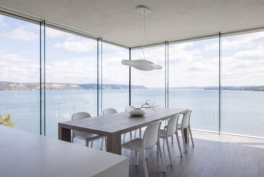 Dining Table at Glass Corner of Cantilever Floating Above Lake