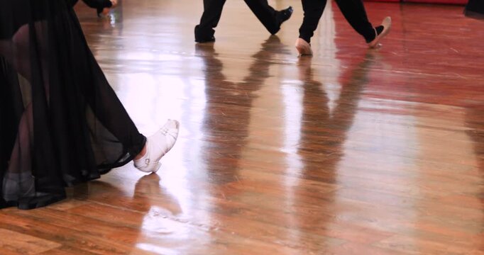 Juvenile-class dancers practicing Standard-style dance moves on the floor