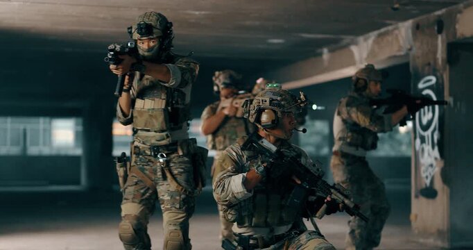 Military tactical team advances through dark parking structure with weapon lights on