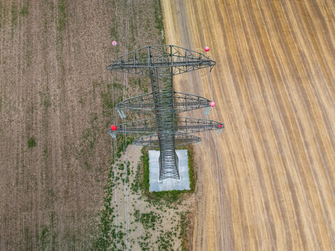 Aerial view of power lines and towers crossing farmland near Ercsi, Hungary