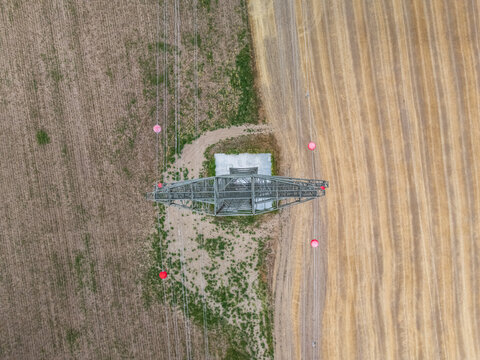 Aerial view of power lines crossing summer farmland near Ercsi, Hungary