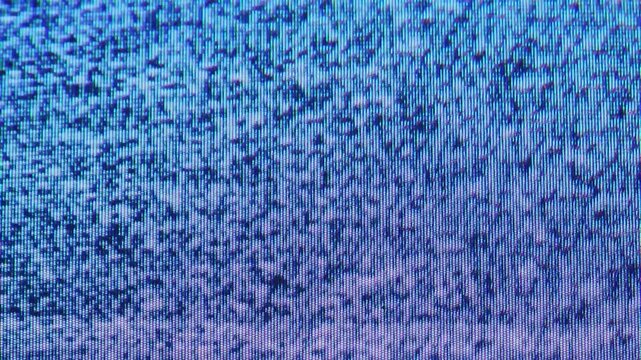 Blue and violet screen static flickers in a dense pixel pattern