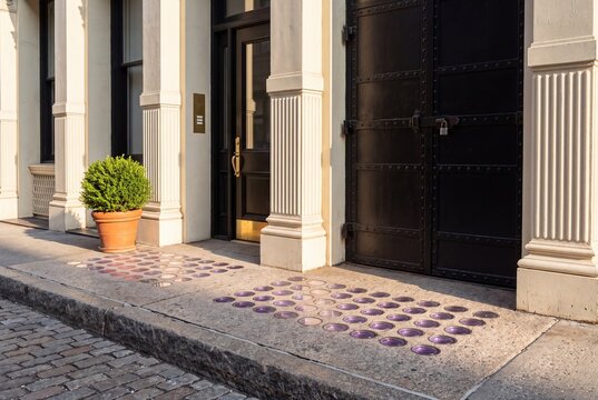 Ground Floor Iron Loading Door and Granite Vault Light Sidewalk