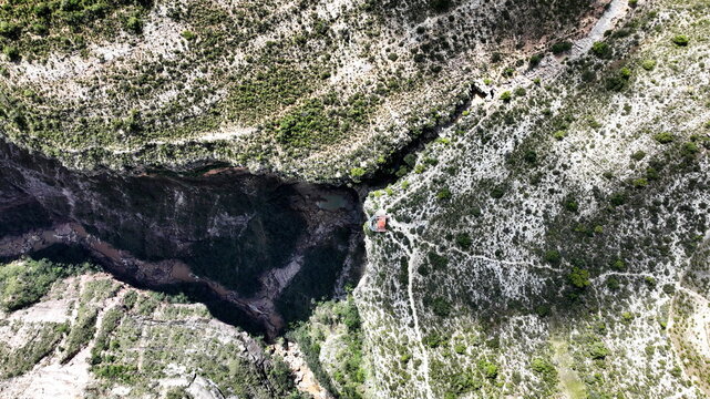 Aerial view of El Vergel canyon featuring steep rocky cliffs, lush vegetation, and a winding river flowing through the deep gorge in Torotoro, Potosi Department, Bolivia.