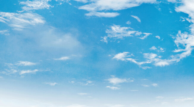 
Clear blue sky with soft, wispy clouds