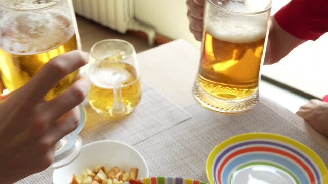 4K footage of camera panning up from crayfish to friends toasting with glasses of beer, cheers celebration