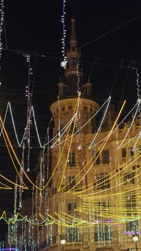 Festive Street Lights Around Historic Building at Night