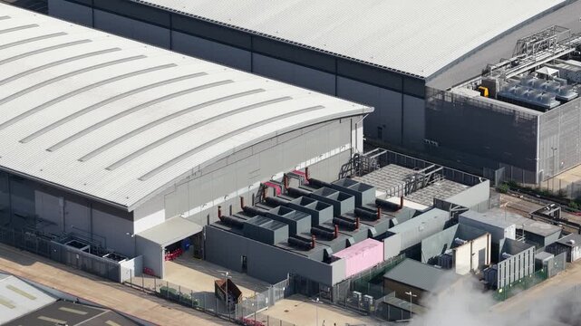 Aerial drone view of Slough industrial estate in the UK, featuring a major cluster of data centers, power infrastructure and facilities supporting AI, cloud computing and digital services.